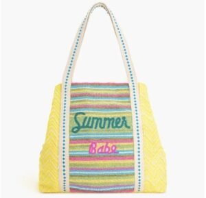 Handcrafted colorful striped beach bag for Summer 2025 featuring 'Summer Babe' embroidery and geometric patterned straps.