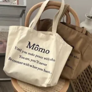Sustainable heavy-duty canvas tote bags in warm neutral tones showing retro-inspired serif typography and inspirational text.